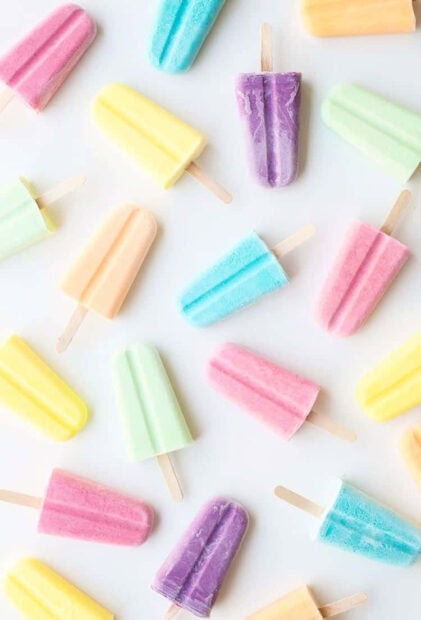 Colorful popsicles in pastel shades on a white background