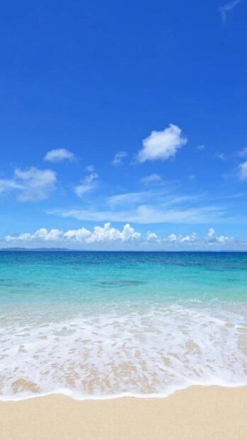 Clear blue sky above the turquoise sea and sandy beach in summer