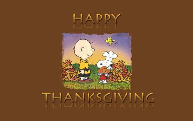 Charlie Brown watches Snoopy, dressed as a chef, carry a roasted turkey while Woodstock flies overhead among colorful autumn leaves