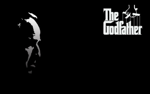 Vito Corleone's profile silhouette emerges from darkness beside the classic film logo on a stark black background