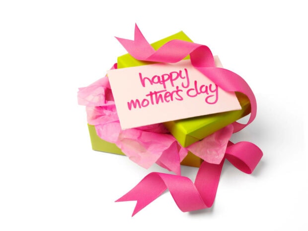 Green gift boxes overflow with pink tissue, tied with a bright ribbon, displaying a thoughtful card on a clean white background, rendered in HD
