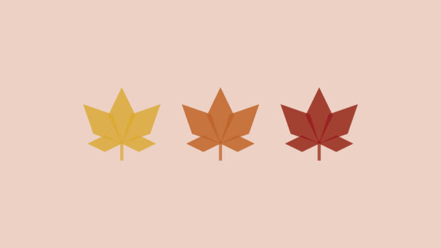 Geometric leaves display vibrant autumn hues on a soft background