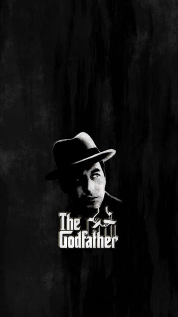 Michael Corleone, wearing a fedora, gazes upward in a stark monochrome portrait, positioned above the film's iconic logo and puppet strings on a textured black background