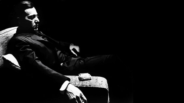 Michael Corleone sits reflecting in a stark, high-contrast black and white illustration, bathed in shadow