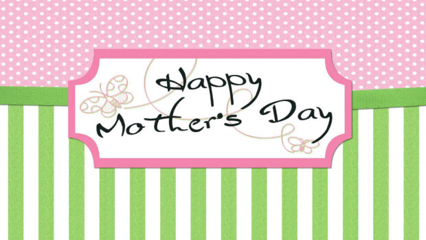 Pink polka dots and green stripes divide a background, framing a white label with handwritten text