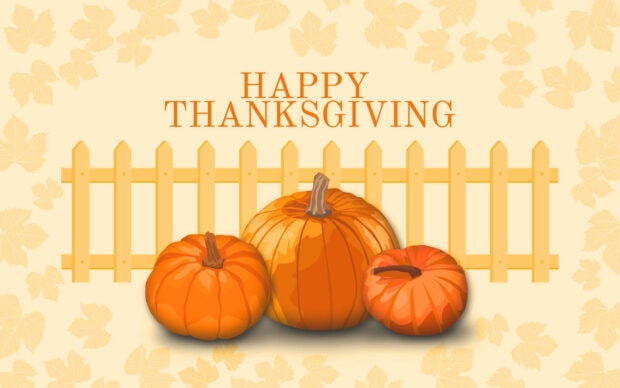 Three round orange pumpkins sit before a light yellow picket fence, with subtle autumn leaf patterns decorating the cream background