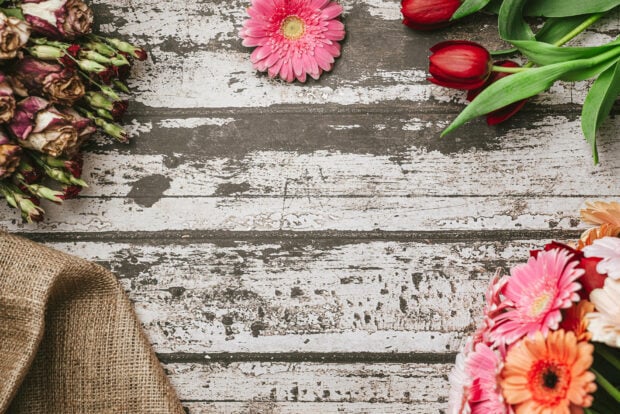 Spring laptop wallpaper hd laptop a spring bouquet of vibrant flowers on rustic wooden surface with burlap sack