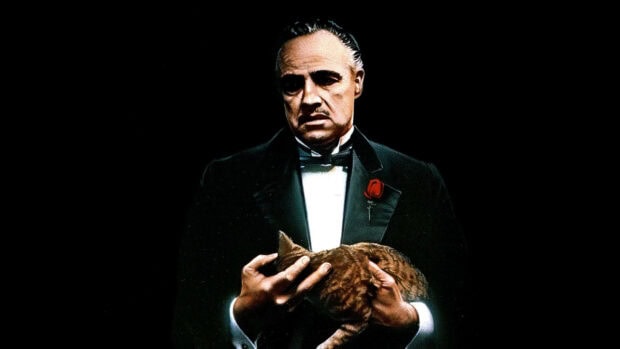 Vito Corleone gently cradles a tabby cat, dressed in a sharp tuxedo with a red lapel rose, against a stark, deep black backdrop