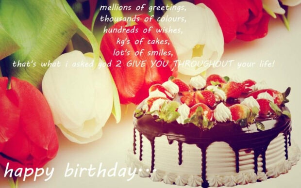A festive birthday wallpaper featuring a chocolate cake with strawberries, fresh tulips, and a 'happy birthday' message
