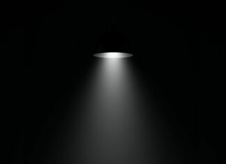 A black aesthetic wallpaper featuring a mysterious dark leather armchair under a single spotlight in a minimalist setting