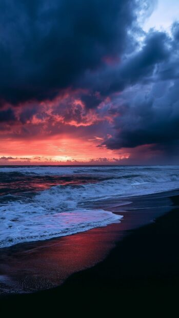 A black aesthetic wallpaper showing dramatic ocean waves crashing on a dark beach at sunset with vivid red and purple clouds