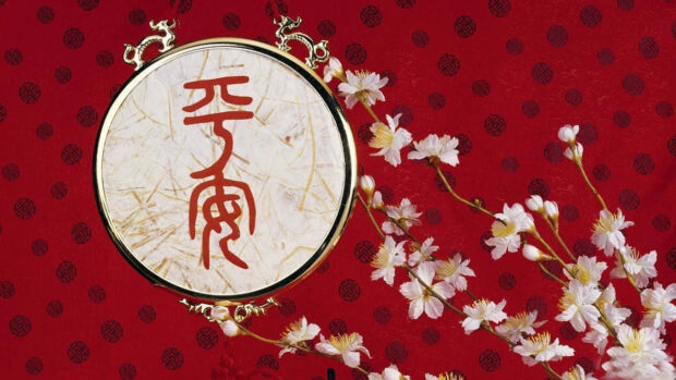 An elegant Chinese New Year wallpaper featuring a red background, white plum blossoms, and a golden-framed emblem with Chinese calligraphy