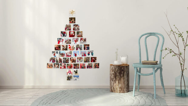 A unique Christmas Collage Wallpaper showing a minimalist Christmas tree formed by small photos on a white wall in a modern room
