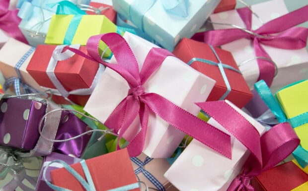 A birthday wallpaper displaying a vibrant pile of colorful wrapped gifts with ribbons and bows