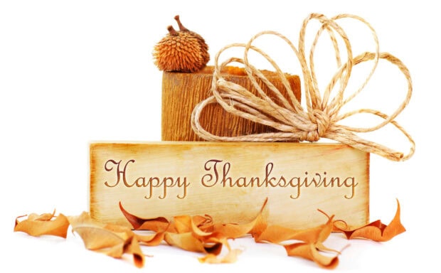 A cute Thanksgiving wallpaper featuring a rustic wooden sign with "Happy Thanksgiving" text on a clean white background with autumn decorations