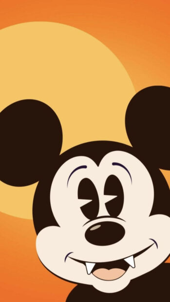 Disney Halloween wallpaper featuring a close-up cartoon of Vampire Mickey Mouse with fangs on an orange background