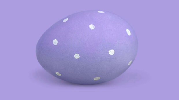 A vibrant Easter egg wallpaper showcasing a single light purple egg with silver polka dots on a matching background