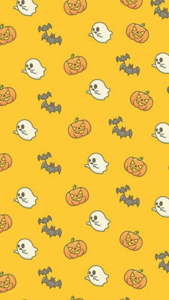 A cute yellow Halloween iPad wallpaper featuring a repeating pattern of cartoon ghosts, pumpkins, and bats