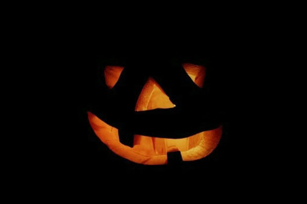 A classic glowing jack-o'-lantern in the dark makes a spooky Halloween iPad wallpaper