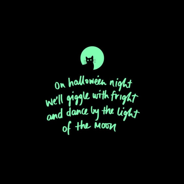 A minimalist Halloween iPad wallpaper featuring a glowing green quote and a black cat silhouette under a moon