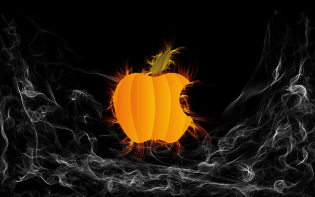 Halloween Macbook Wallpaper featuring an Apple logo shaped pumpkin glowing with fire on a dark smoky background