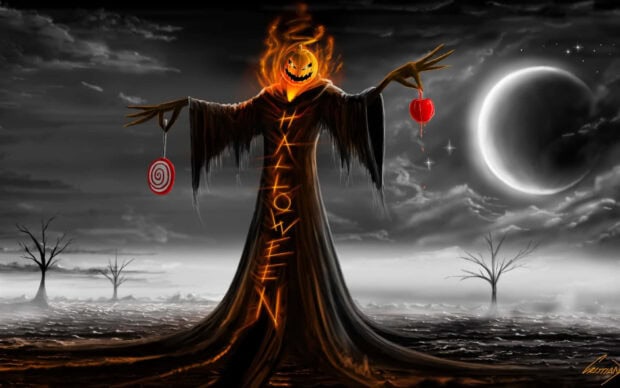 A dramatic Halloween Macbook Wallpaper featuring a flaming pumpkin-headed figure holding candy against a grayscale moonlit sky