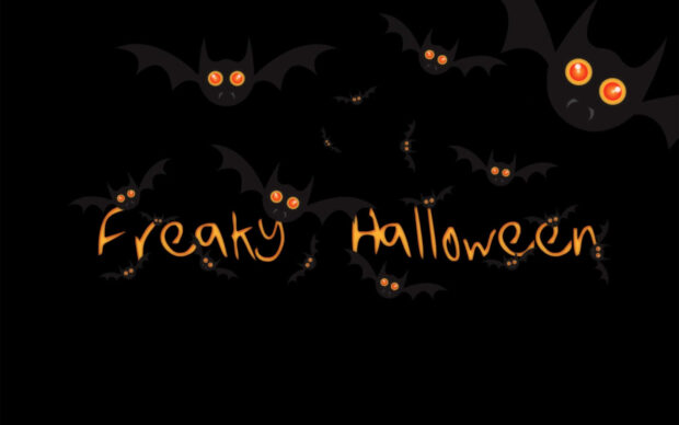 A spooky Halloween Macbook wallpaper featuring cartoon bats with glowing orange eyes and "Freaky Halloween" text
