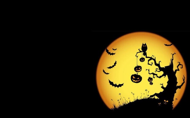 A spooky Halloween Macbook Wallpaper featuring a silhouetted tree with hanging jack-o'-lanterns and flying bats against a large full moon