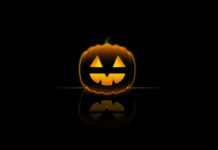 A minimalist Halloween Pumpkin Wallpaper featuring a glowing jack-o'-lantern with a reflection on a dark background
