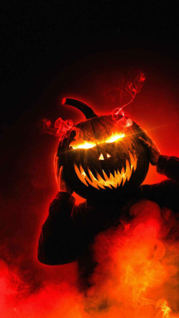 A dynamic Halloween Pumpkin Wallpaper depicting a person with a menacing glowing pumpkin head surrounded by dramatic red and orange smoke