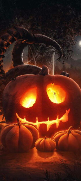 A Halloween Pumpkin Wallpaper showing a scary glowing jack-o'-lantern with a spider hanging inside and smaller pumpkins below, set against a dark, eerie background