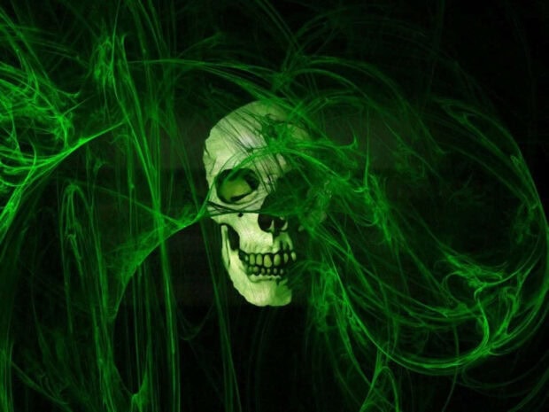 Halloween Skeleton Wallpaper showcasing a skull surrounded by swirling green smoke on a dark background
