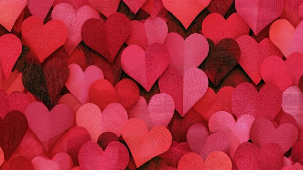 Heart wallpaper featuring a vibrant, dense pattern of red and pink paper hearts with textured details