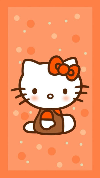 A charming Hello Kitty Fall Wallpaper featuring Hello Kitty in a brown outfit on an orange polka dot background