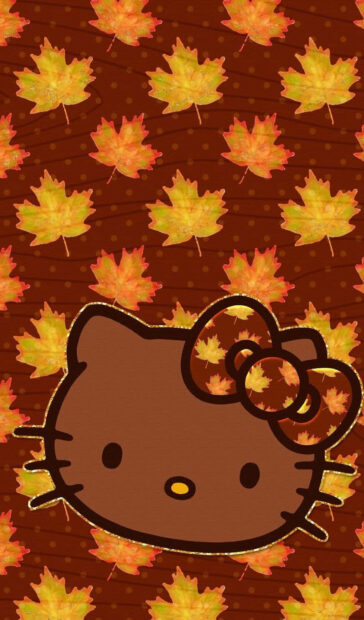 A unique Hello Kitty Fall wallpaper featuring a brown Hello Kitty head with a leaf-patterned bow against a background of golden and orange autumn leaves
