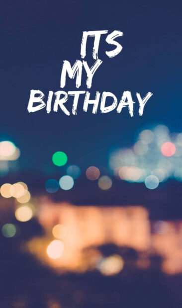 A stylish 'ITS MY BIRTHDAY' text overlayed on a blurred night city lights background, ideal as a Birthday Wallpaper