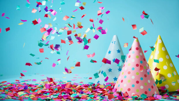Its My Birthday Wallpaper with vibrant confetti falling around colorful party hats on a blue background