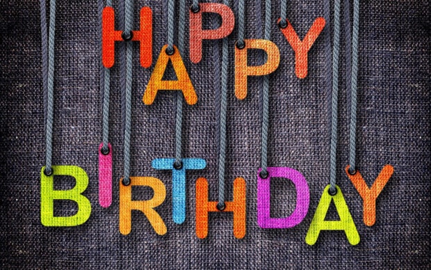 Its My Birthday Wallpaper with colorful hanging letters spelling 'Happy Birthday' on a textured burlap background