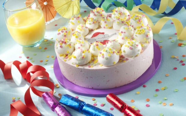 Its My Birthday Wallpaper showcasing a delightful pink birthday cake adorned with white frosting and colorful sprinkles, surrounded by festive party decorations