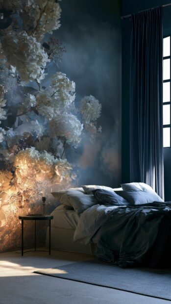 Flower wallpaper for a moody bedroom featuring large white flowers on a dark blue wall above a bed, illuminated by warm light