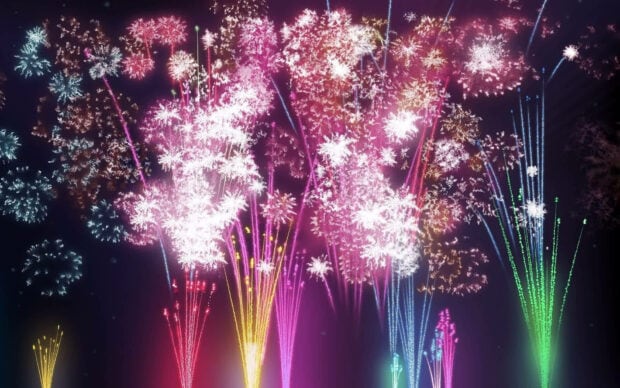 A vibrant New Years Eve Wallpaper featuring a dazzling display of colorful fireworks exploding in the night sky
