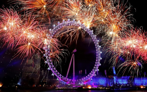 A vibrant New Years Eve wallpaper showcasing the London Eye illuminated with spectacular fireworks