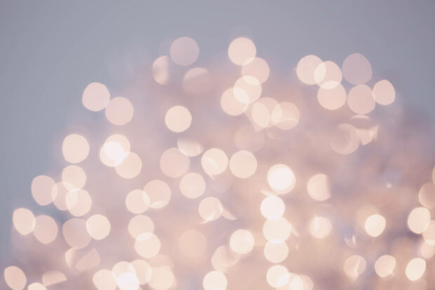 A soft pastel New Years Eve wallpaper featuring a beautiful arrangement of blurred bokeh lights
