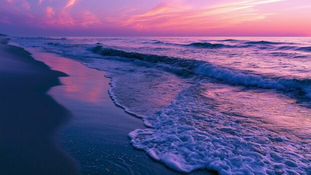 Ocean wallpaper featuring vibrant purple waves crashing onto a sandy beach under a dramatic pink and purple sunset sky