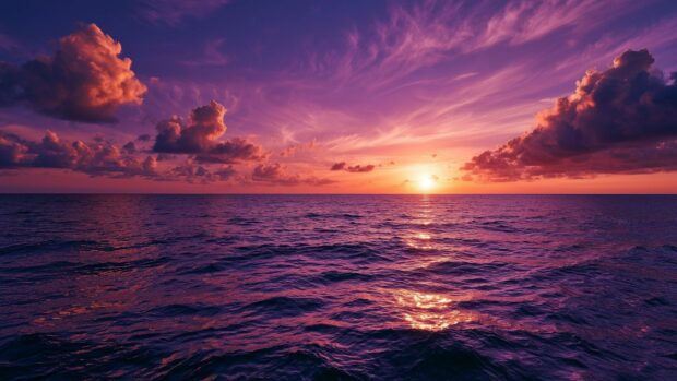 Ocean wallpaper showing a breathtaking sunset with vibrant purple and orange clouds over calm waters