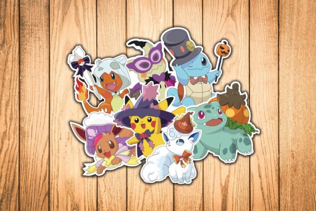 A charming Pokemon Halloween wallpaper featuring cute Pokemon characters dressed in various Halloween costumes on a wooden background