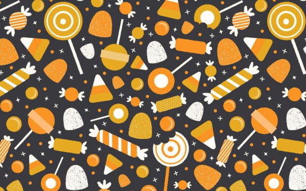 Preppy Halloween Wallpaper featuring a seamless pattern of various orange, white, and yellow candies like lollipops and candy corn on a dark background