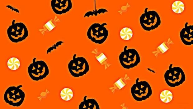 Preppy Halloween Wallpaper with a vibrant orange background patterned with black jack-o'-lanterns, bats, and small candies