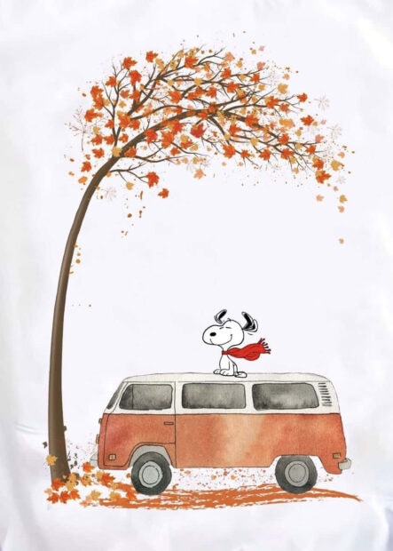 A delightful Snoopy fall wallpaper depicting Snoopy on a vintage van under an autumn tree with colorful falling leaves against a clean white background