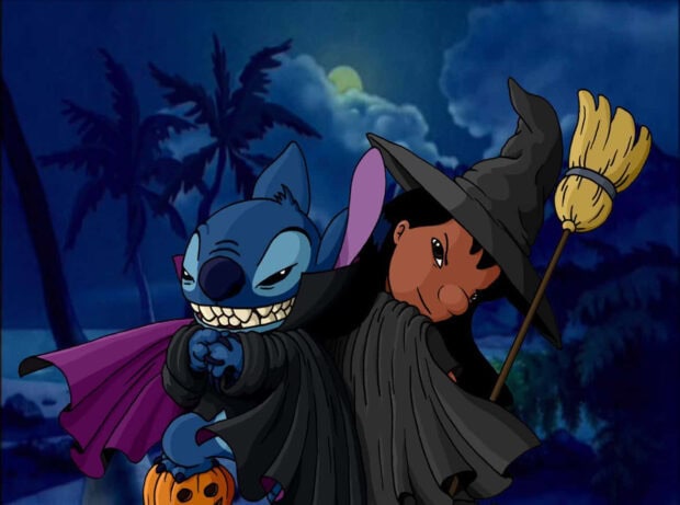 An adorable Stitch Halloween wallpaper showing Stitch as a vampire holding a pumpkin alongside Lilo dressed as a witch with a broom against a dark, spooky night sky